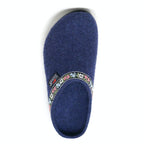 The 'Women's Edelweiss Wool Clog - Medium' is a single blue slipper made of cozy Merino wool, featuring a floral-patterned trim around the opening that resembles hand-embroidered bands.