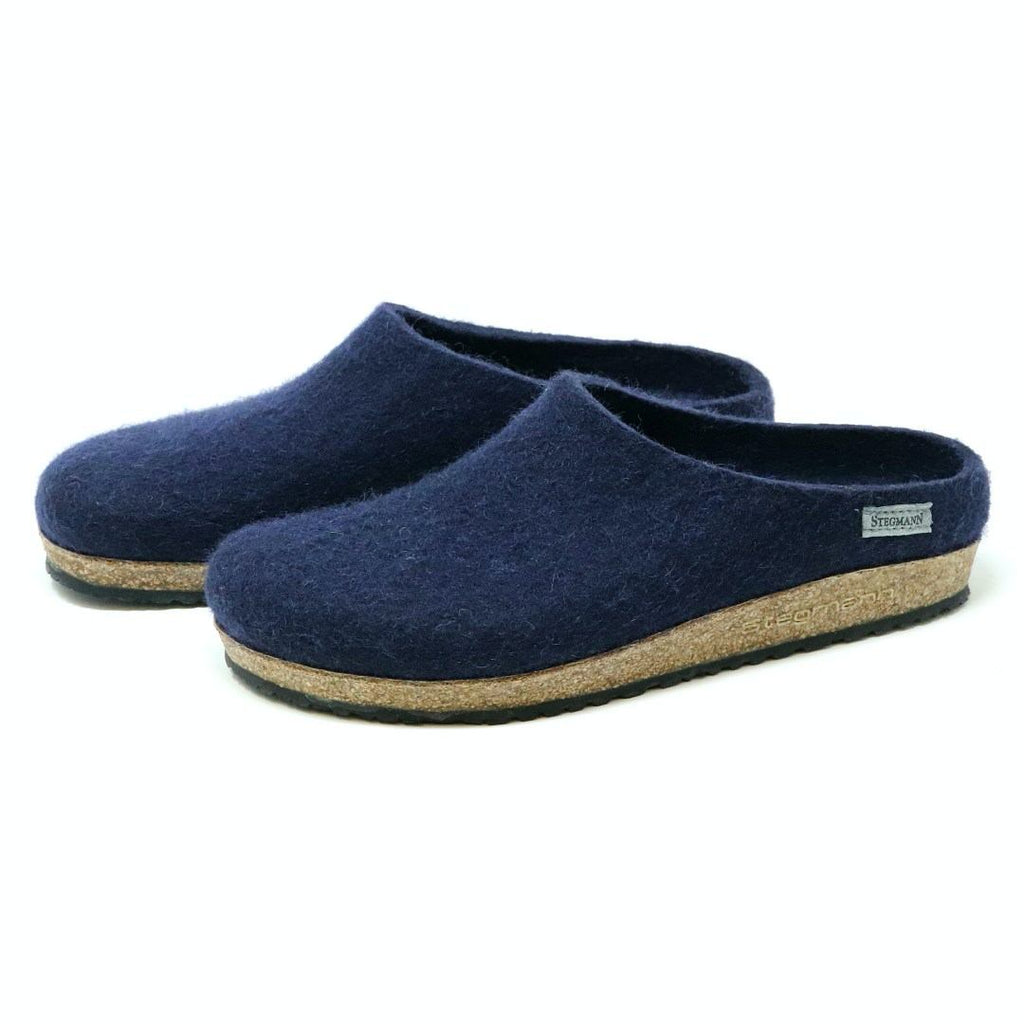 Men's Essenz Wool Clog in a dark blue color, crafted from a Merino wool blend with cork soles and designed to angle left, is displayed on a white background.