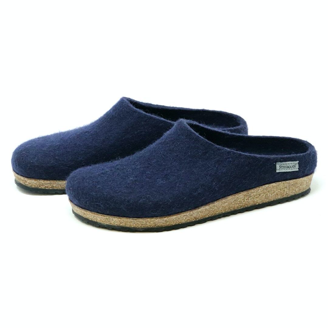 Men's Essenz Wool Clog in a dark blue color, crafted from a Merino wool blend with cork soles and designed to angle left, is displayed on a white background.