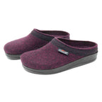 The Women's WoolFlex Wool Clog - Wide is a pair of purple Merino wool felt clogs, adorned with black trim and soles, and includes a brand tag on one shoe. These stylish clogs offer excellent arch support and all-day comfort.