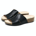 Introducing the Women's Layna Leather Wedge Sandal: black slip-on sandals with an open toe, a sustainable cork midsole, and a cushioned suede footbed for ultimate comfort.