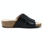 Side view of the Women's Layna Leather Wedge Sandal, a black leather slide with a cushioned suede footbed and eco-friendly cork wedge sole, featuring an open toe design against a plain white background.