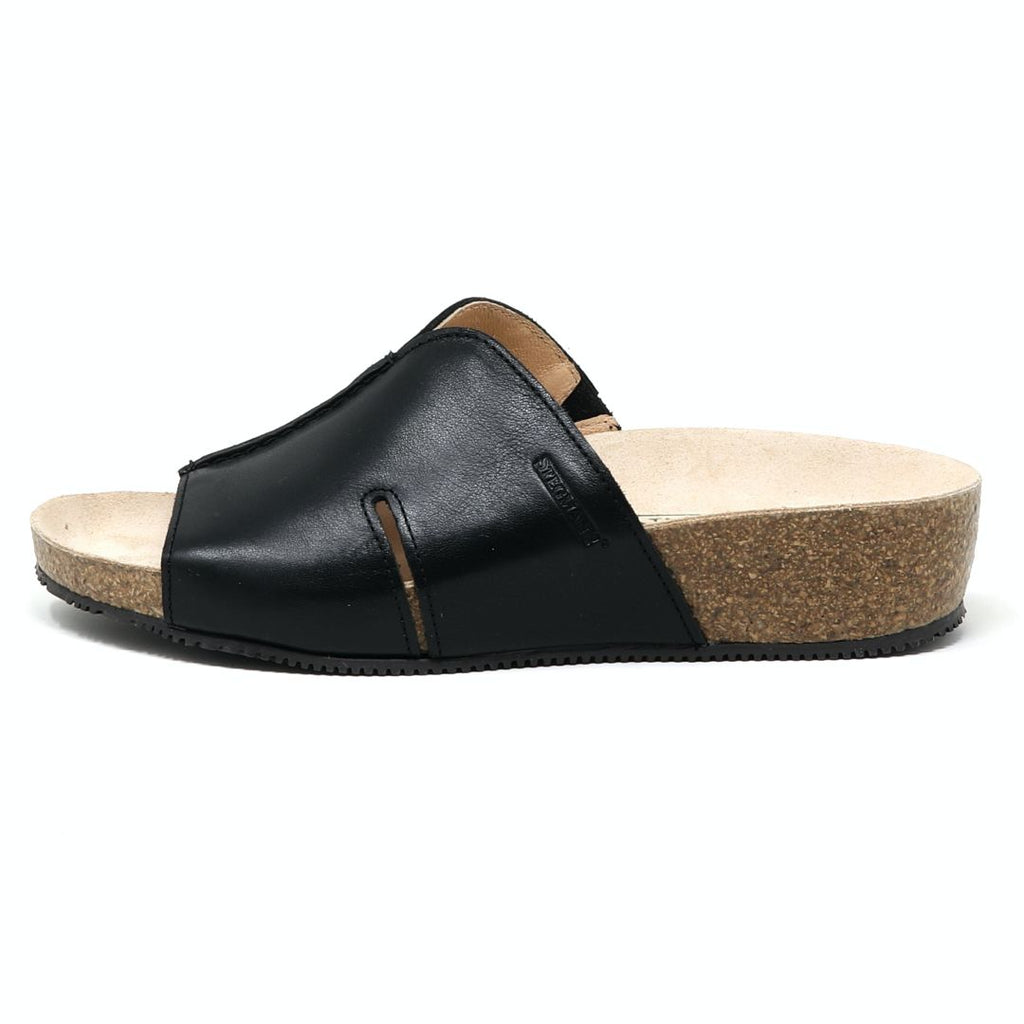 The Women's Layna Leather Wedge Sandal, crafted in black leather with a sustainable cork midsole and closed toe design, features a cushioned suede footbed for extra comfort, shown on a plain background.