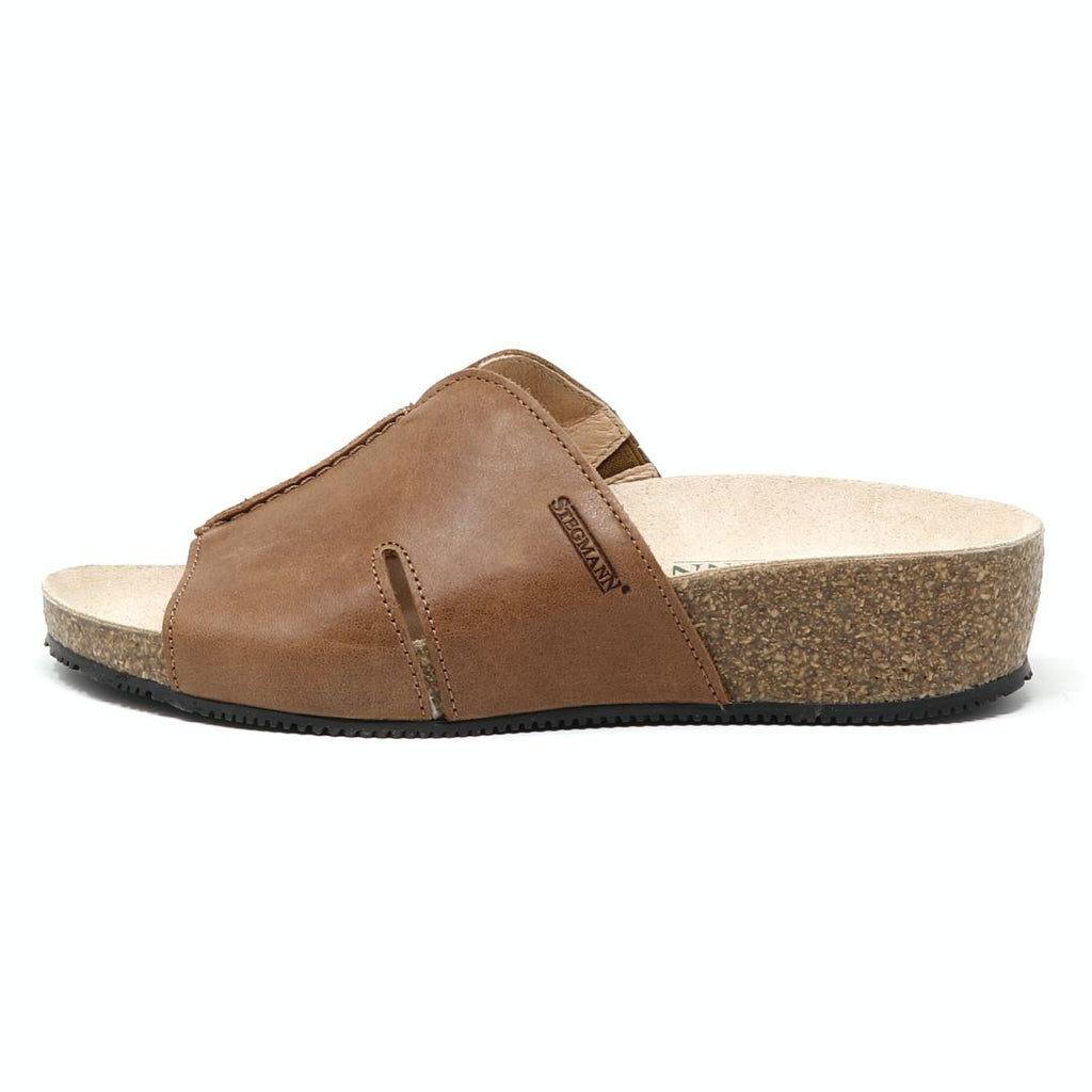 The Women's Layna Leather Wedge Sandal boasts a brown leather open-toe design, cushioned suede footbed, sustainable cork midsole for comfort, and a small platform heel for added style—all elegantly viewed from the side.