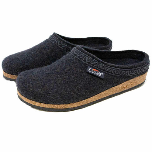 The Men's Original 108 Wool Clog in dark gray is crafted from soft Merino wool and features a supportive cork sole with black trim. Adorned with a small logo tag on the side, these clogs offer style and comfort in every step.