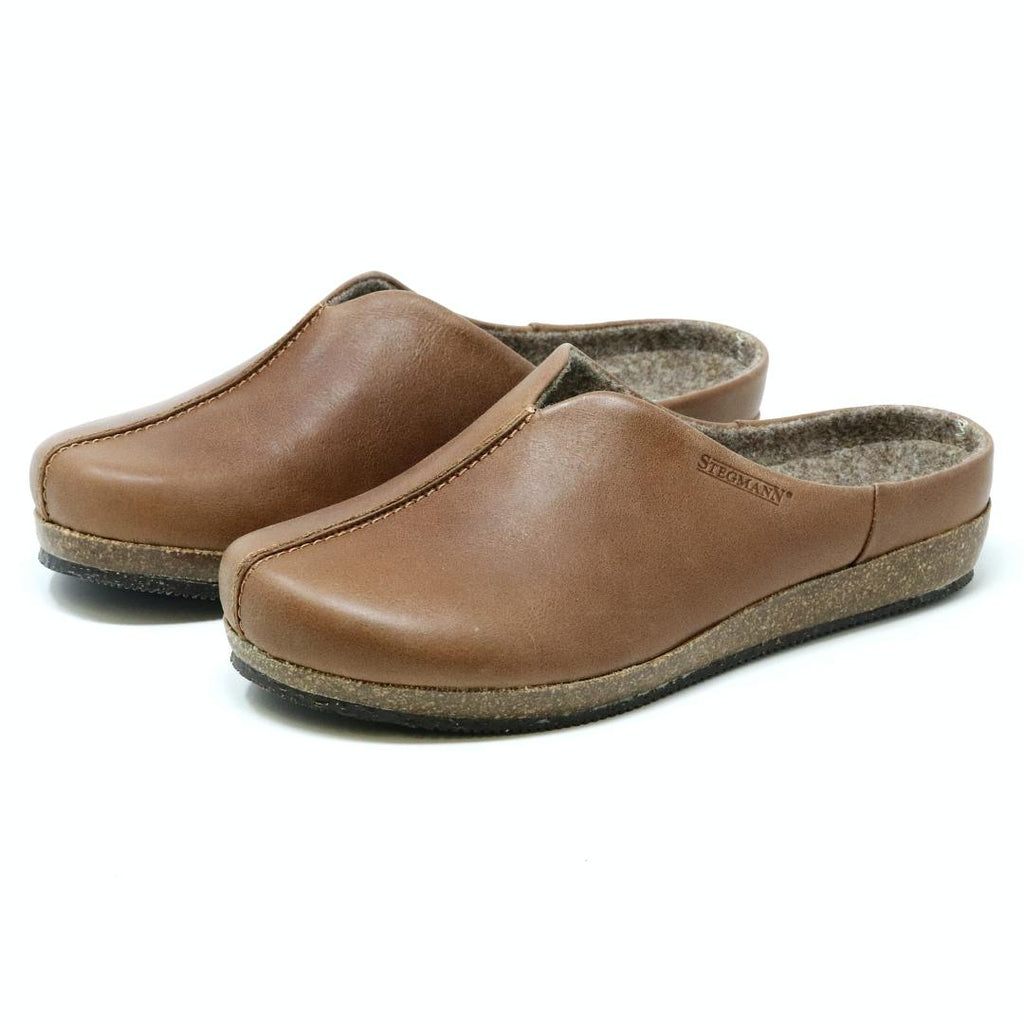 Women's Maria Leather Mules in brown feature textured cork and latex support soles on a white background.
