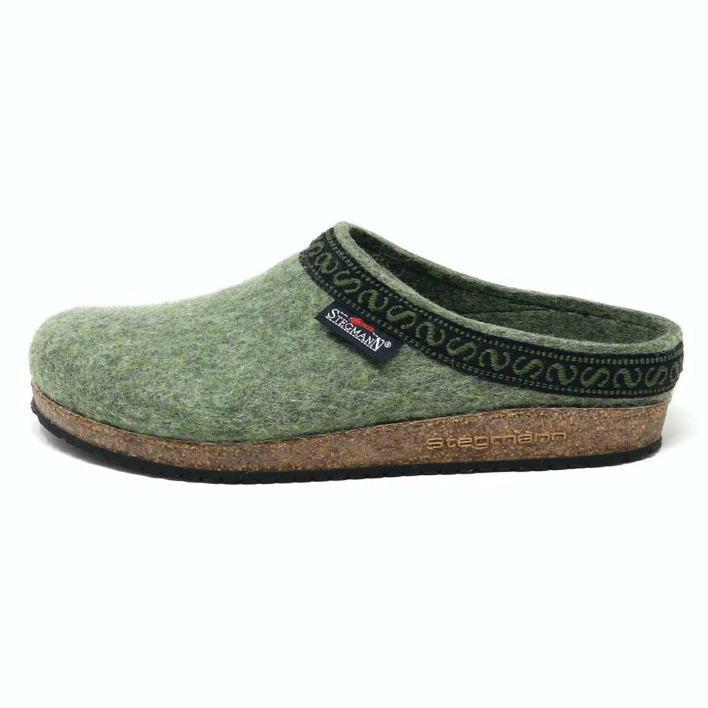 The Women's Original 108 Wool Clog - Medium is crafted from luxurious Merino wool felt and features a cork and latex sole for enhanced comfort and durability. It includes black trim, a decorative pattern, and a logo tag on the side.