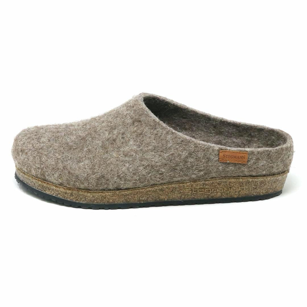 The Women's Eco Wool Clog is crafted with sustainable gray wool, a cork latex footbed, a cork sole, and features a small brown leather tag on the side with text.