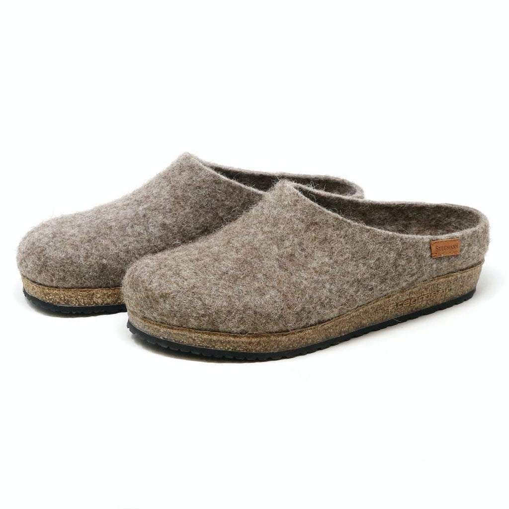 The Women's Eco Wool Clog features gray wool slippers with cork latex footbeds and a small leather tag, crafted from sustainable wool.