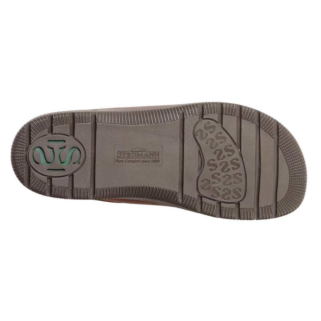 The image displays a Men's Halstatt Wool Lined Leather Clog, featuring textured rubber sole patterns with the Stegmann logo prominently at the center.
